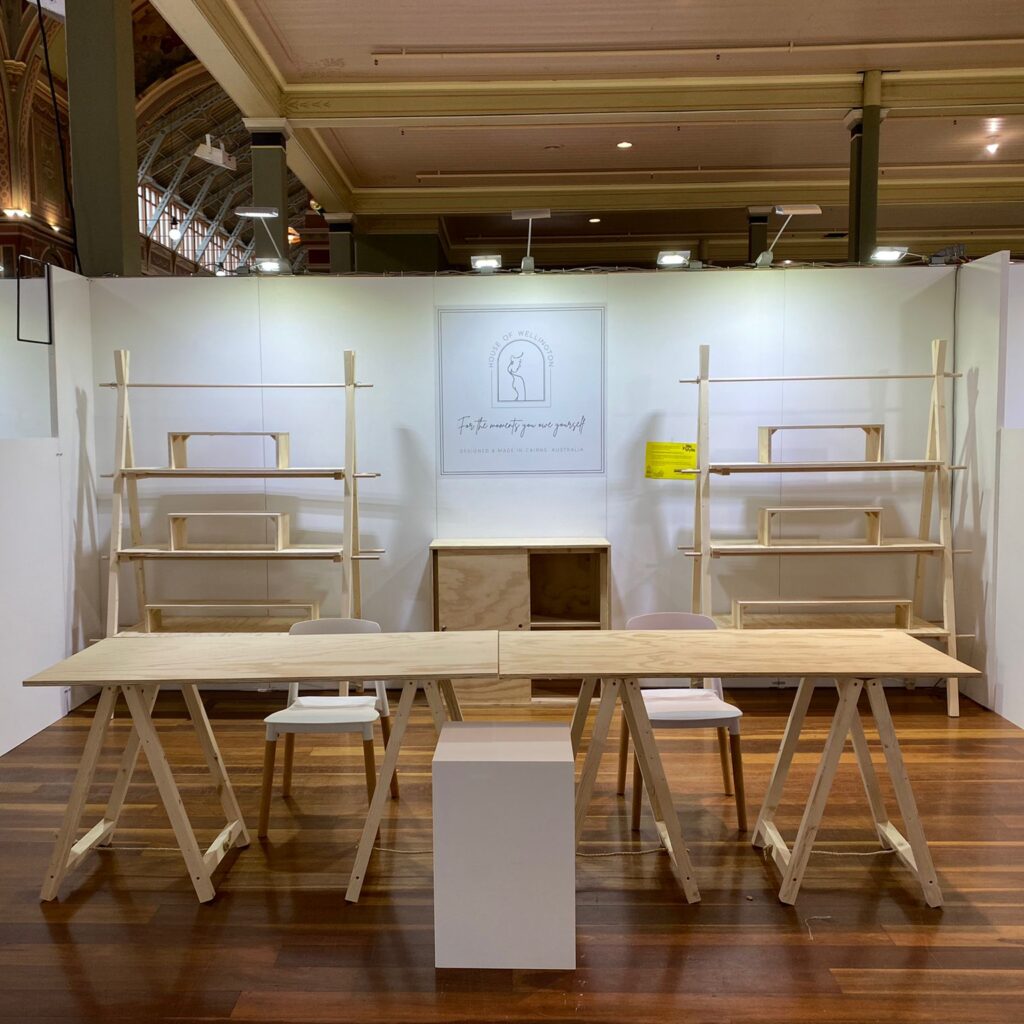 two three tier a-frames, two trestle tables, two white belloch chairs, one white plinth, one enclosed counter and risers