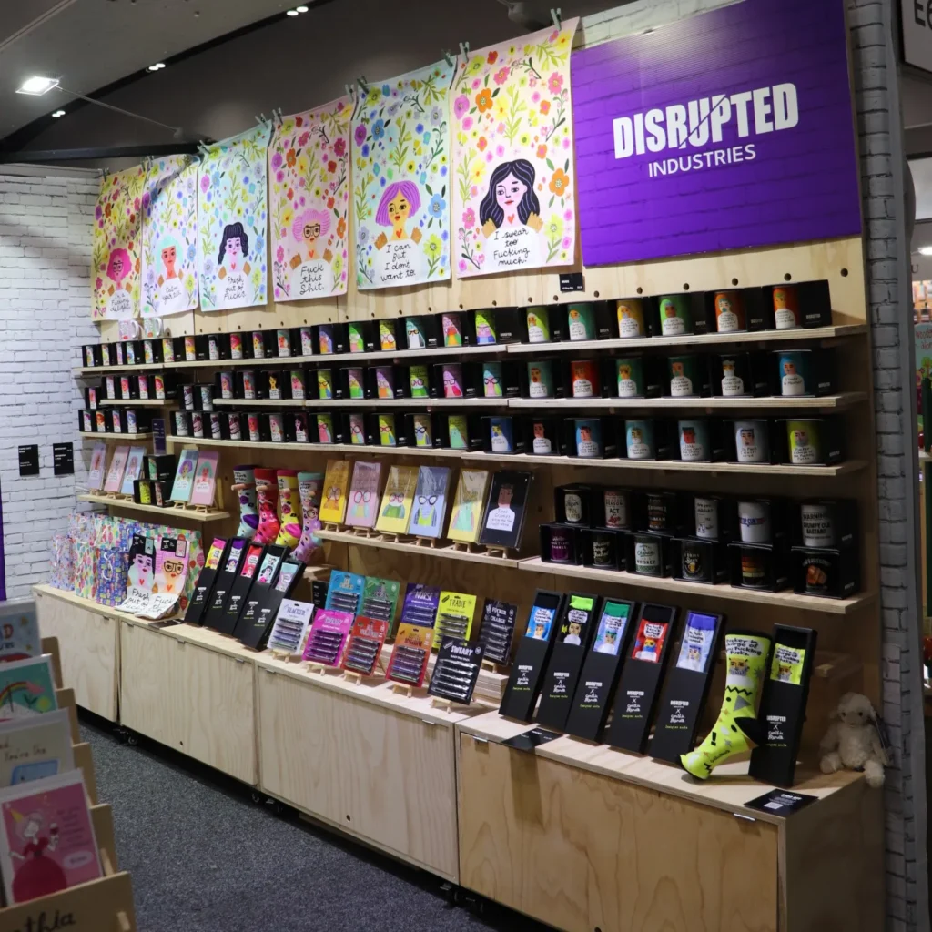 create an expo stand - disrupted industries using pegboard with cabinets along their back wall