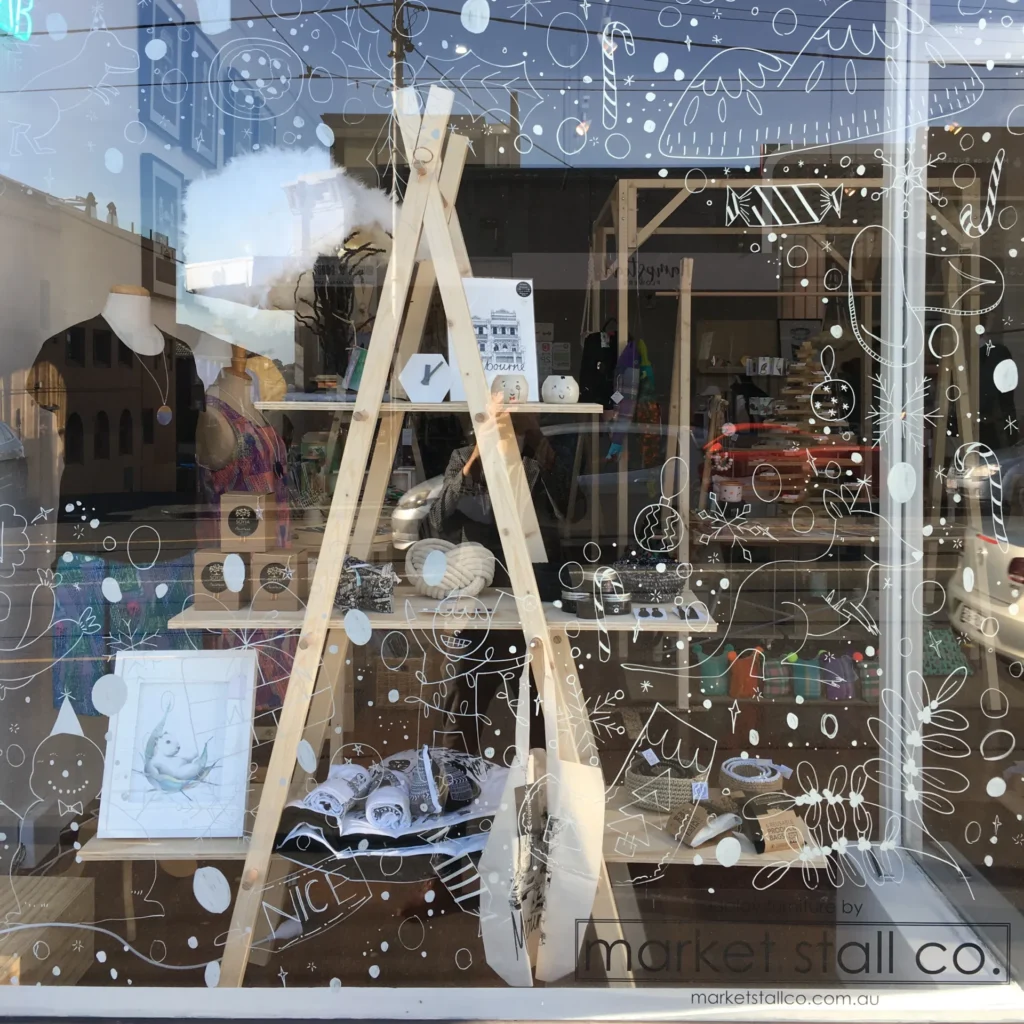 ladder a-frame in a window shop display - dexus collins st market stand in black - plan for christmas in retail