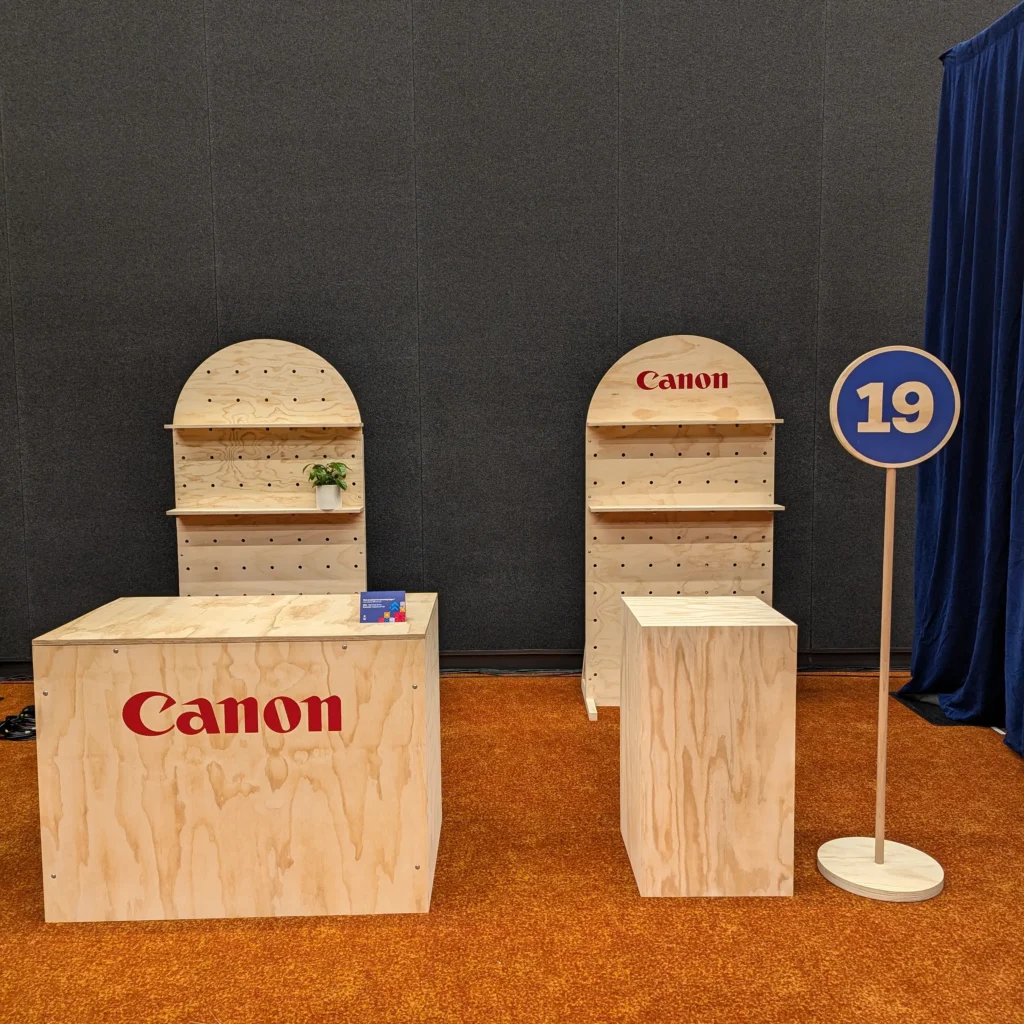signage - back wall and counter vinyl decal letting for cannon at officeworks tradeshow