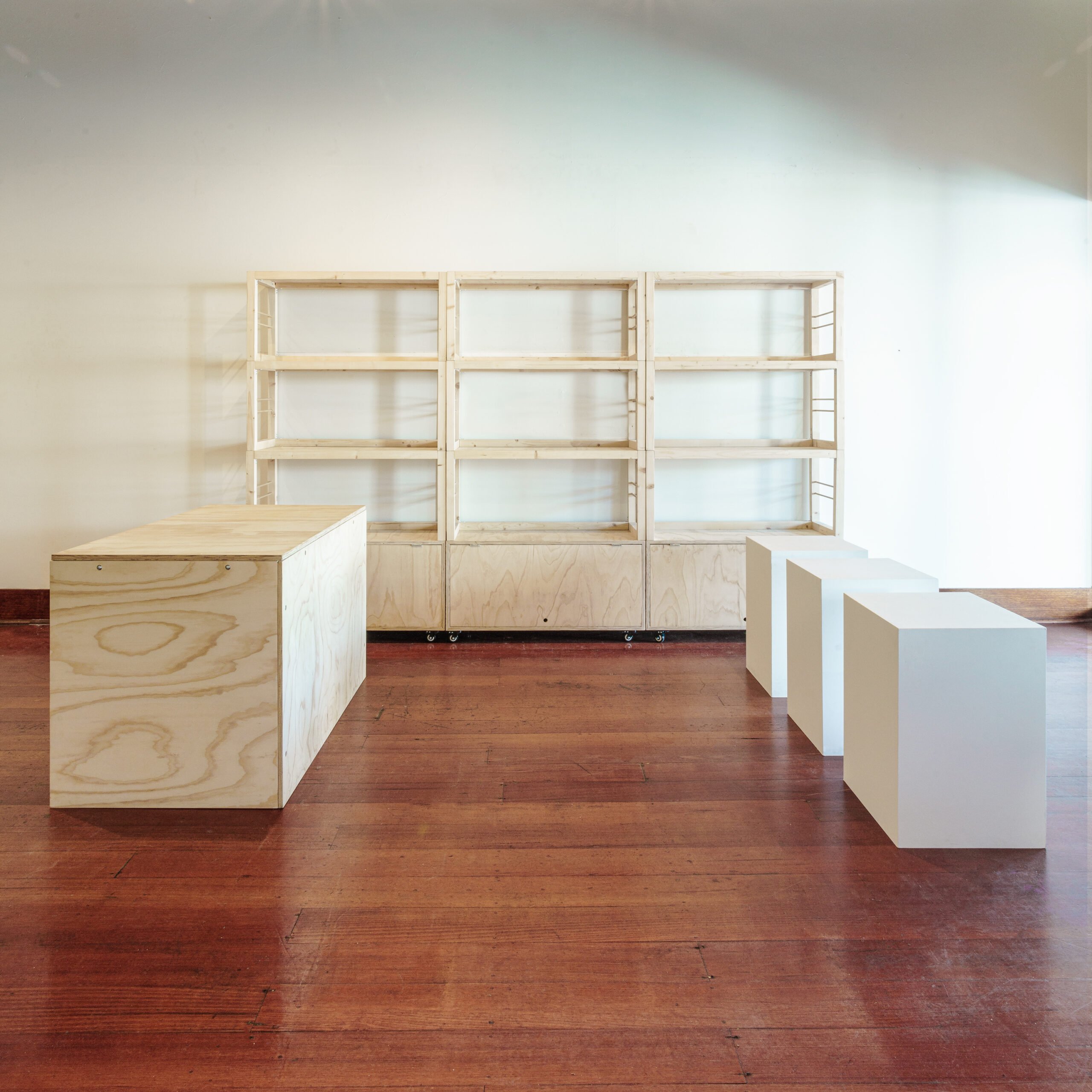 three stacked shelving units, one msc counter and three white plinths
