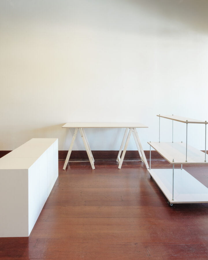 four white plinths, one white centered floating stand, one trestle table