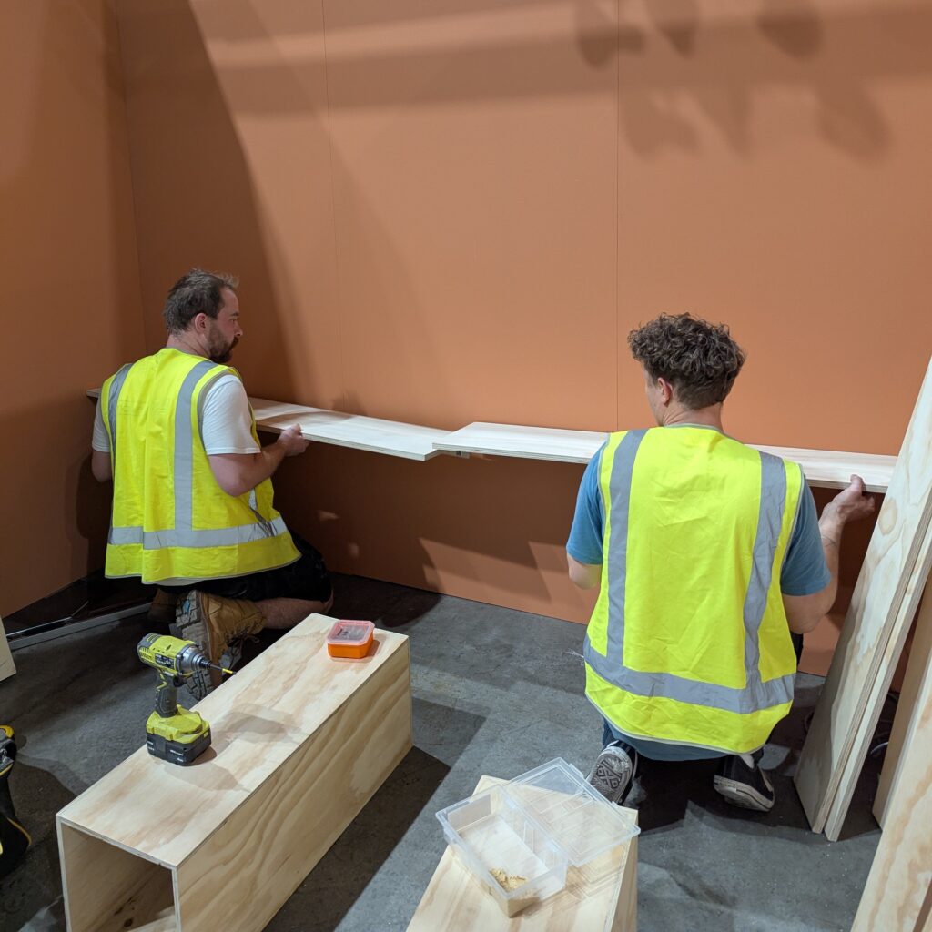 msc team on site at life instyle tradeshow installing wall mounted shelving