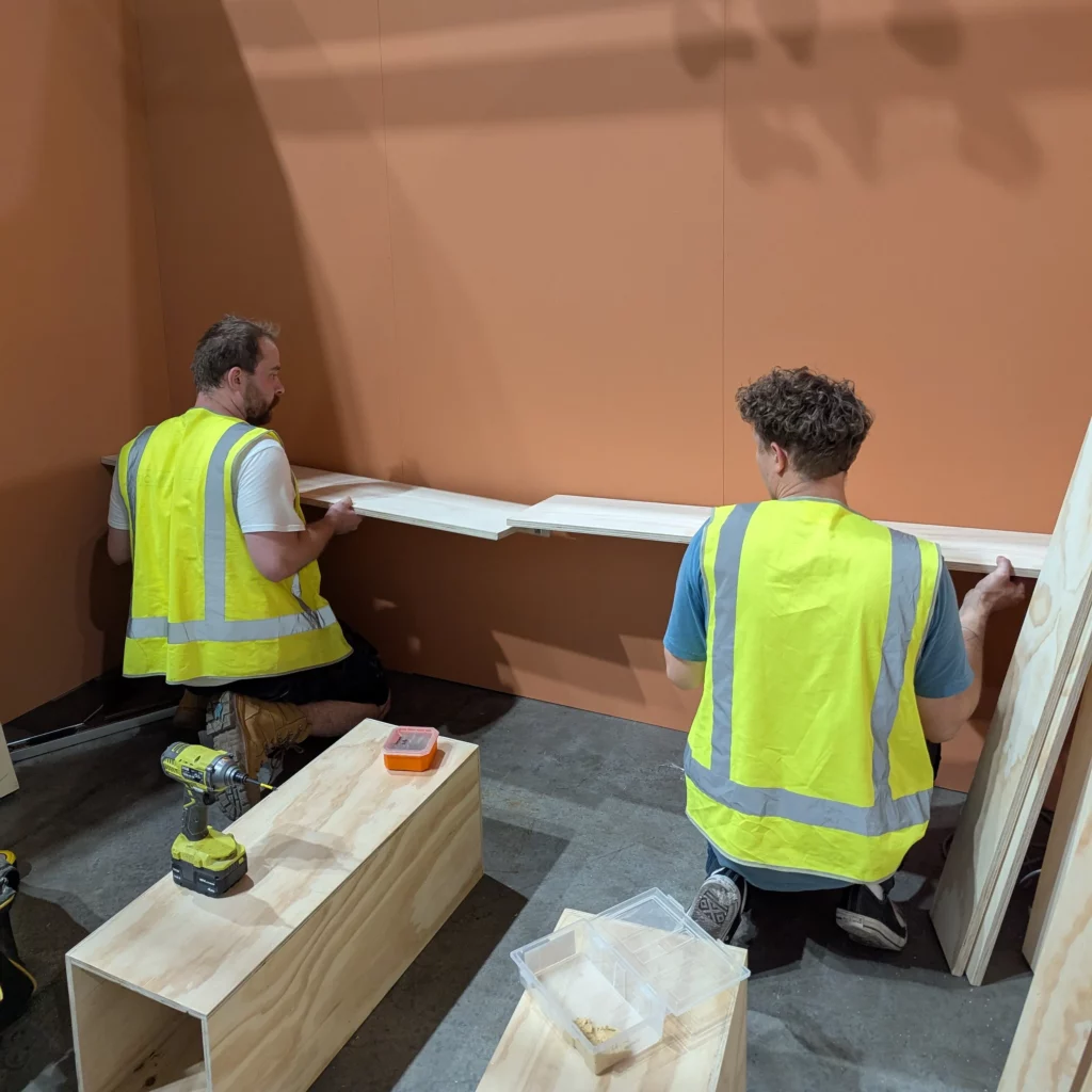 msc team on site at life instyle tradeshow installing wall mounted shelving